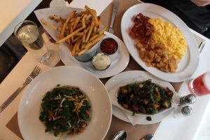 kale salad, Truffle Fries, brussels sprouts, egg scramble at Delicatessen