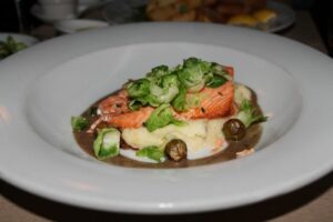 Salmon on mashed potatoes with brussels sprouts and truffle at Mercer Kitchen