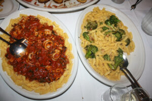 Gluten free pasta with red sauce and calamari and white sauce with broccoli at Carmine's