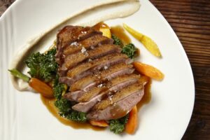Roasted Duck Breast on kale from Hyde Sunset Kitchen + Cocktails