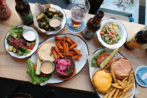 The American burger and falafel burger on a gluten free roll with brussels sprouts at Black Tap Burger