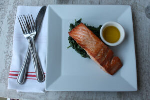 Salmon with sautéed spinach at Louie's Oyster Bar & Grille