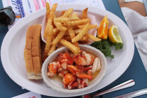 Lobster roll on a gluten free roll with french fries at The Lobster Roll