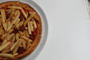 Americano Pizza with french fries and hotdog on gluten free pizza crust at Ribalta Pizza