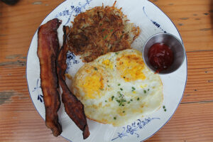 "Our eggs" with bacon and home fries at Commissary at The Line Hotel