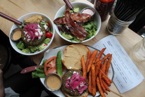 The falafel burger on a gluten free roll and burgers over salad at Black Tap Burger