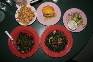 The Happiest Burger with nobread, french fries, brussels sprouts, kale salad at The Happiest Hour