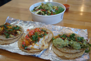 The Ensalada Yucateca, Healthy Taco, Basic Taco, and Veggie Taco from District Taco
