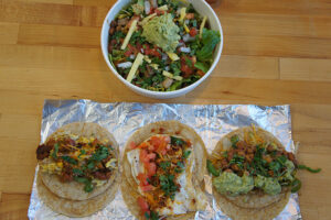 The Ensalada Yucateca, Healthy Taco, Basic Taco, and Veggie Taco (on corn tortillas) from District Taco