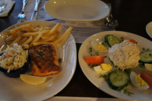 Salmon with coleslaw and french fries and crabmeat avocado salad at Legal Sea Foods