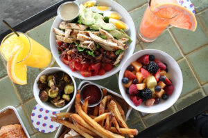 The Cobb Salad, brussels sprouts, fruit salad, fries at Mr. Purple