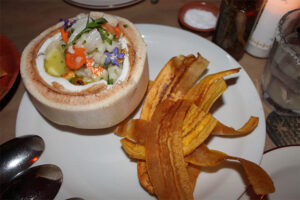 White fish ceviche in coconut with fried plantains at El Chavo