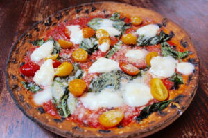 Gluten free REGINELLA pizza with mozzarella di bufala, cherry tomatoes and basil at Olio E Piu